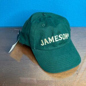 This is a green Jameson Irish Whiskey adjustable baseball cap with yellow embroi